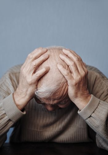 hypertension-symptoms Old man holding his head