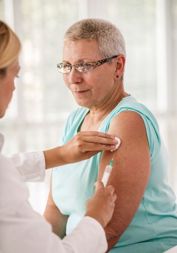 flu-diagnostics Doctor giving an injection to an older patient